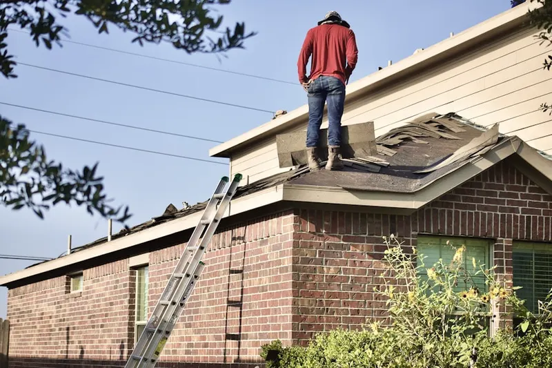 Professional roofer working on a residential roof in Yellow Springs